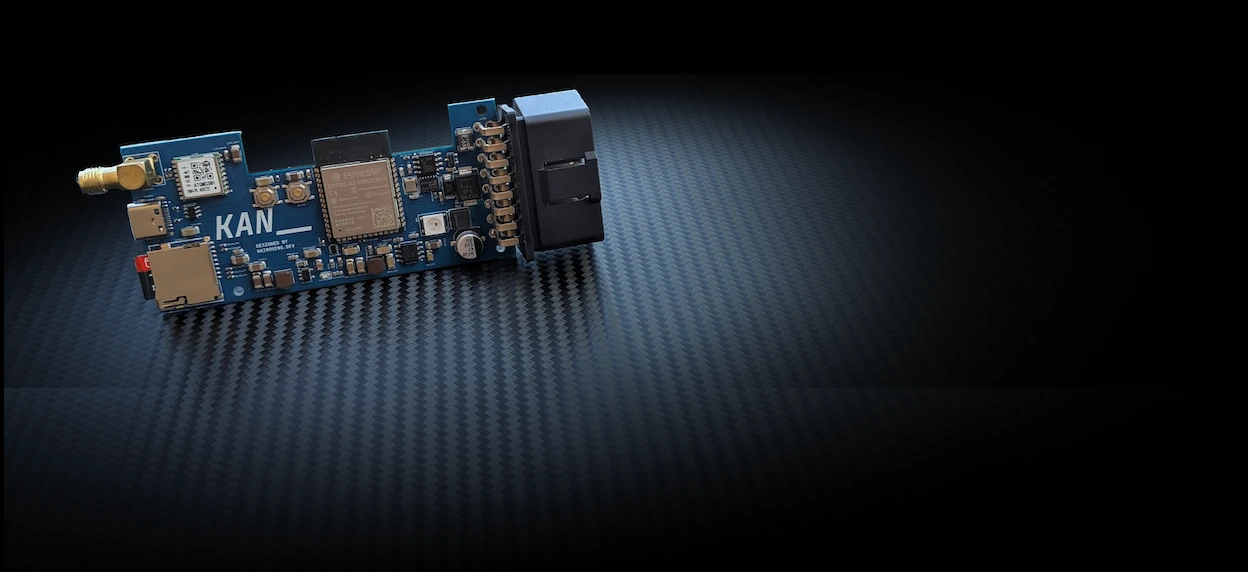 KAN_1 board with OBD-II connector, GPS antenna, SD card and ESP32 module, on carbon fibre
